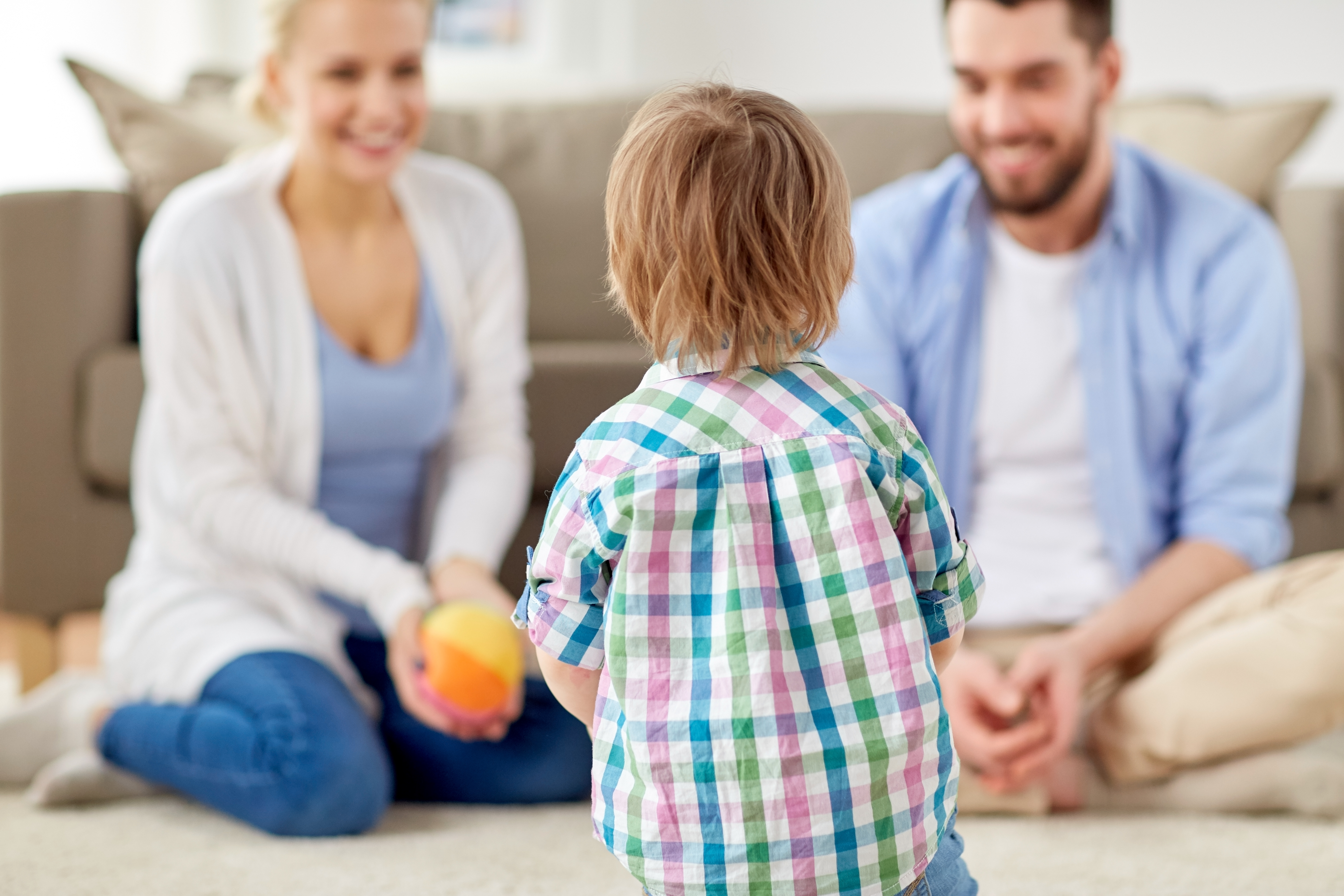 happy family playing with ball at home