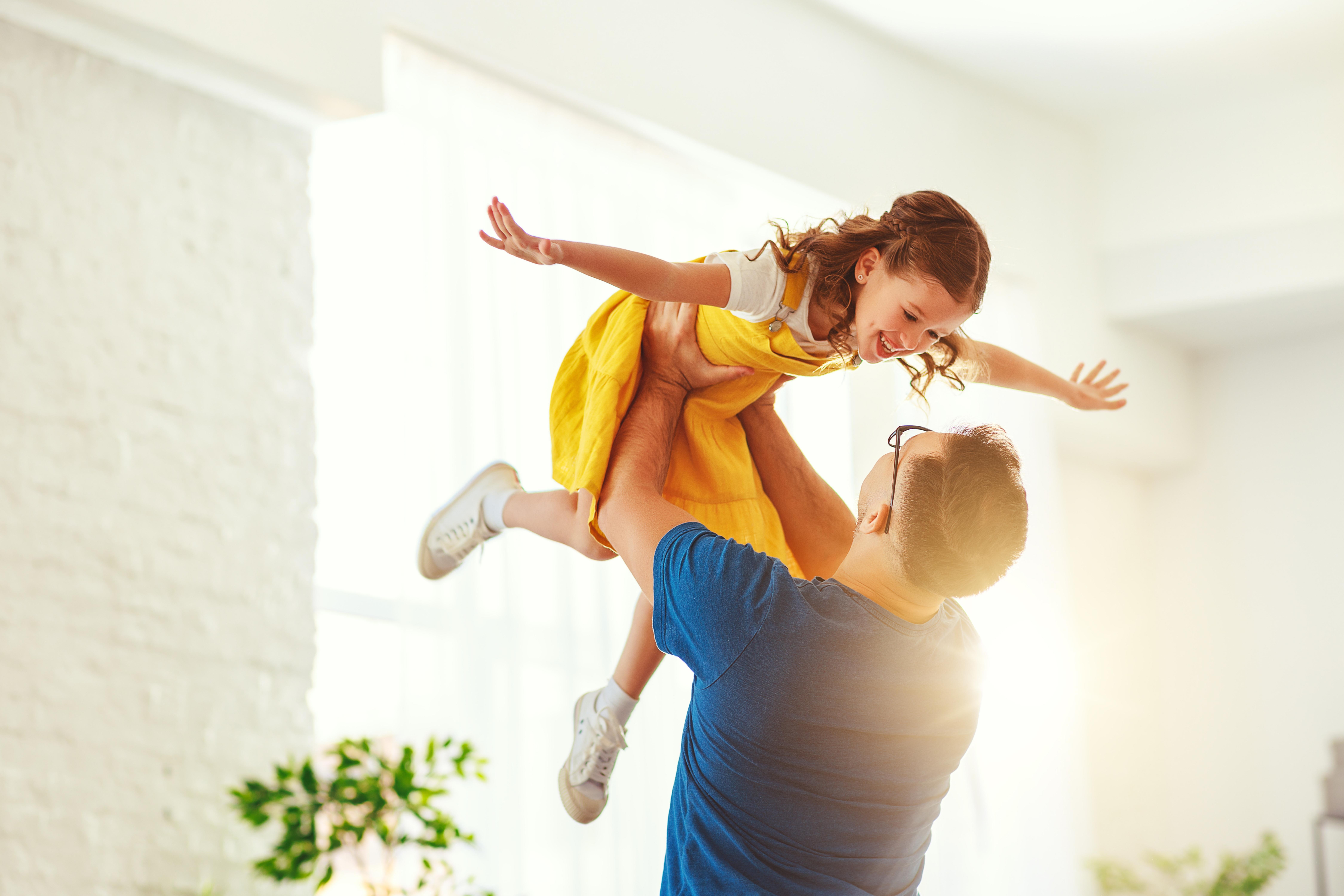 Father's day. Happy family daughterhugs his dad on holiday