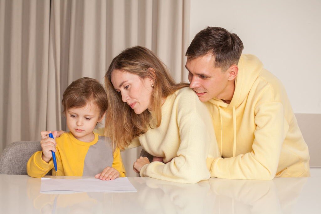 Happy smiling family, parents in yellow clothes, mom and dad wit