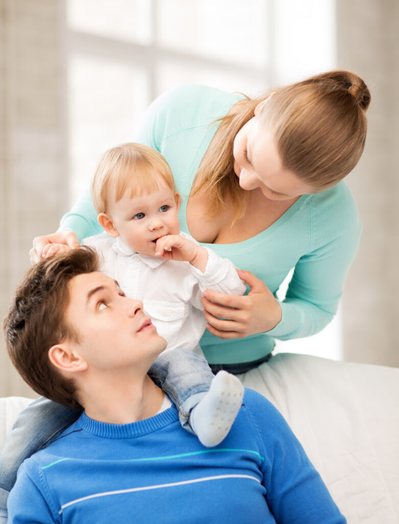 happy parents playing with adorable baby